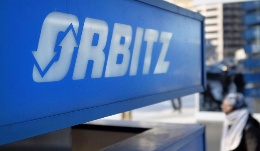 FILE - This Feb. 12, 2015 file photo shows signage for travel booking site Orbitz outside the building that houses its headquarters, in Chicago. The American Hotel & Lodging Association on Thursday, Aug. 6, 2015 issued a statement announcing its opposition to the proposed combination of travel booking sites Expedia and Orbitz, saying that the deal would mean higher prices for vacationers and larger fees for hotel owners. (AP Photo/Kiichiro Sato, File)