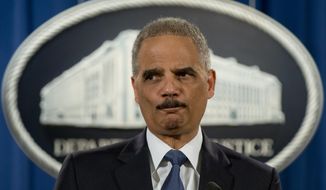Former Attorney General Eric Holder pauses as he speaks at the Justice Department in Washington to discuss the Aug. 9, 2014, shooting in Ferguson, Mo. AP Photo/Carolyn Kaster, File)