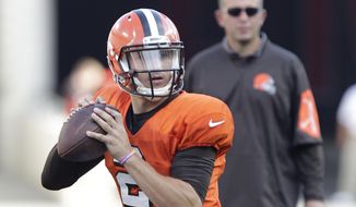 Cleveland Browns quarterback Johnny Manziel drops back to pass during an NFL football training camp scrimmage at Ohio Stadium on Friday, Aug. 7, 2015, in Columbus, Ohio. (AP Photo/Jay LaPrete)