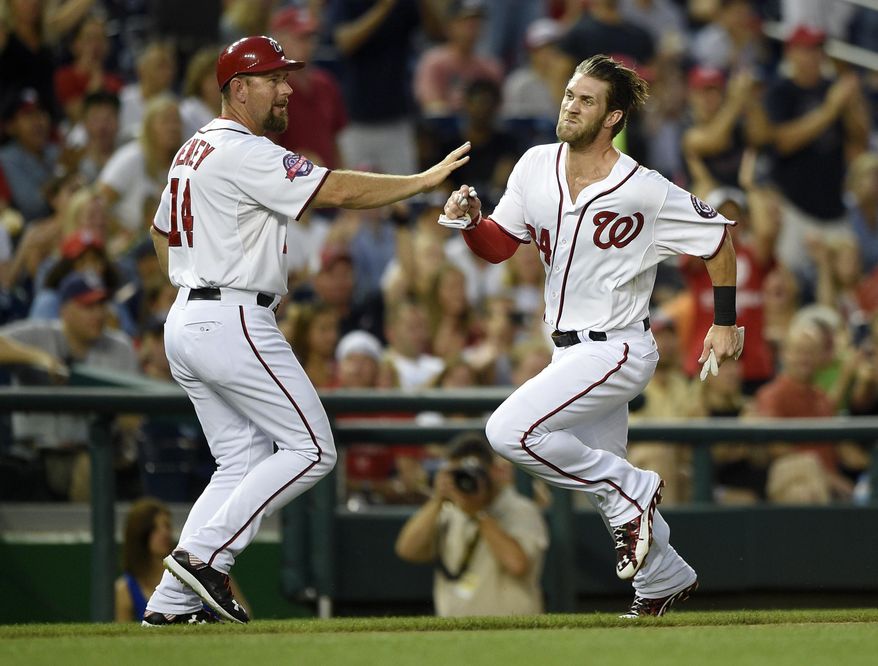 Washington Nationals&#39; Bryce Harper, right, runs past third base coach Bob Henley, left, on his way home to score on a double by Ryan Zimmerman during the fourth inning of a baseball game, Friday, Aug. 7, 2015, in Washington. (AP Photo/Nick Wass) **FILE**
