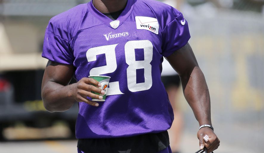 FILE - In this July 26, 2015, file photo, Minnesota Vikings running back Adrian Peterson walks to the practice fields at an NFL football training camp on the campus of Minnesota State University in Mankato, Minn. The attorney for Adrian Peterson says the Minnesota Vikings star running back who was accused of injuring his 4-year-old son is off probation early. Rusty Hardin tells the Star Tribune a judge in Texas agreed that Peterson fulfilled the requirements of his probation and signed the early termination order late last week. (AP Photo/Charles Rex Arbogast, File)
