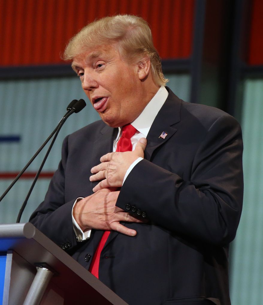 Republican presidential candidate Donald Trump responds to former Arkansas Gov. Mike Huckabee&#39;s closing remarks during the first Republican presidential debate at the Quicken Loans Arena Thursday, Aug. 6, 2015, in Cleveland. (AP Photo/Andrew Harnik) ** FILE **