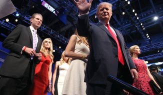 Republican presidential candidate Donald Trump waves as he leaves the stage with his son Eric Trump, left, and daughter, Ivanka Trump. right, after the first Republican presidential debate at the Quicken Loans Arena Thursday, Aug. 6, 2015, in Cleveland. (AP Photo/Andrew Harnik)