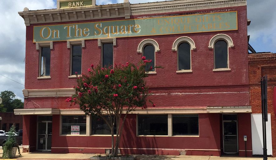This Aug. 6, 2015, shows the old bank building that once housed the office of author Harper Lee's father A.C. Lee on the courthouse square in Monroeville, Ala. The building is for sale, and local officials hope interest in Lee's newly release "Go Set a Watchman" will spur interest in the historic structure. (Anne Marie Bryan/Monroeville Main Street via AP)