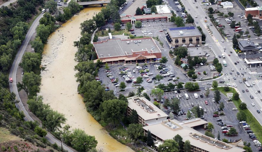 A toxic sludge flows down the Animas River through Durango Colo, on Friday, Aug. 7, 2015, after the Gold King Mine north of Silverton Colo., spilled heavy minerals into the river on Wednesday. Federal environmental officials say it's too early to know whether heavy metals that spilled into a river from a Colorado mine pose a health risk. (Jerry McBride(/The Durango Herald via AP)