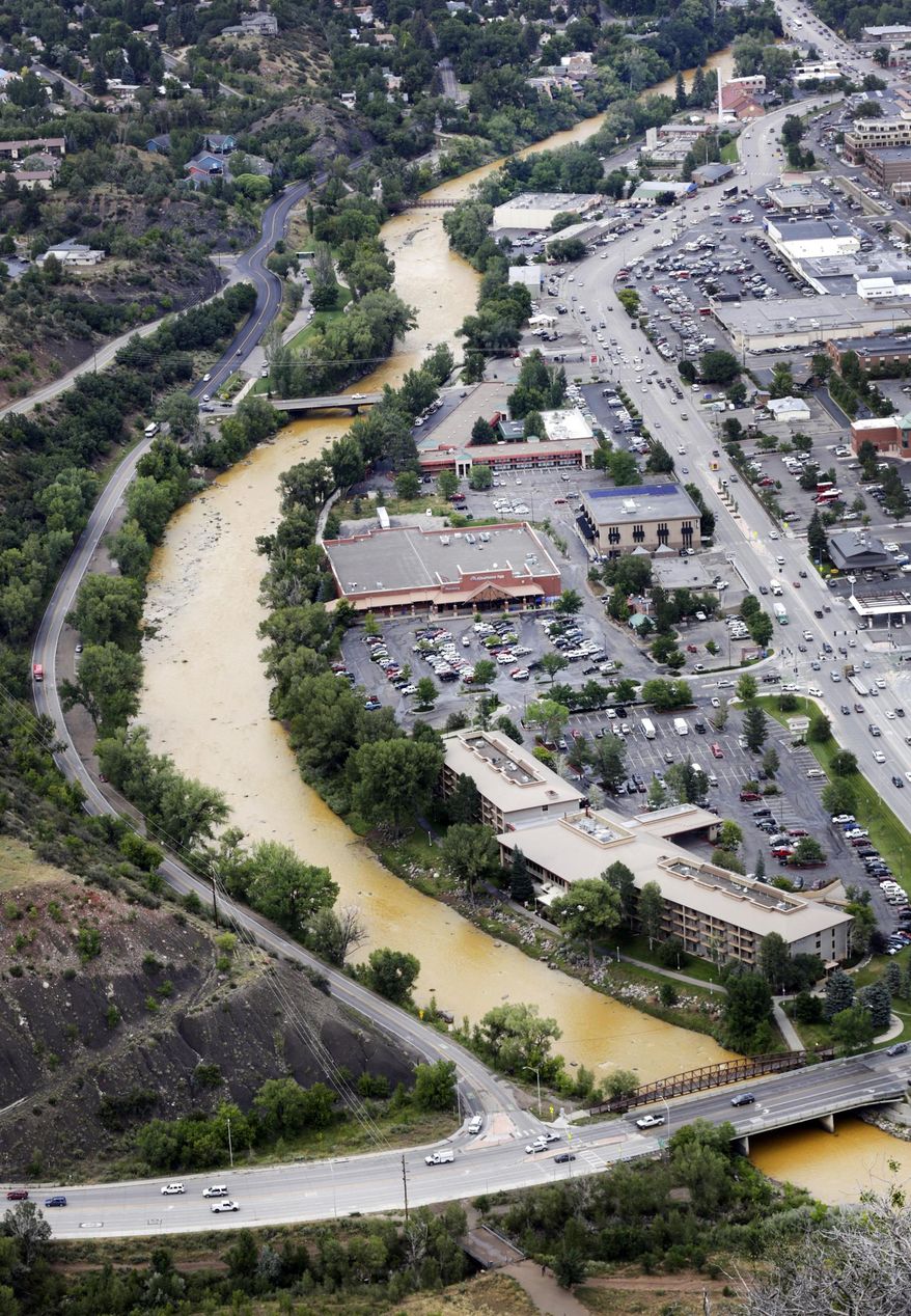A toxic sludge flows down the Animas River through Durango Colo, on Friday, Aug. 7, 2015, after the Gold King Mine north of Silverton Colo., spilled heavy minerals into the river on Wednesday. Federal environmental officials say it's too early to know whether heavy metals that spilled into a river from a Colorado mine pose a health risk. (Jerry McBride(/The Durango Herald via AP)