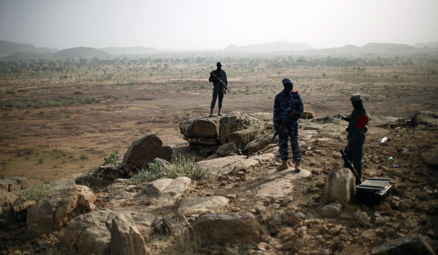 FILE - In this Thursday, Jan. 24, 2013 file photo, Malian troops man an observation post outside Sevare, some 620 kms (385 miles) north of Mali&#x27;s capital Bamako. Four people held by Islamic extremists in a hotel in Sevare in central Mali were freed Saturday, Aug. 8, 2015 by the army and special forces, after fighting since Friday left a number of dead, Mali&#x27;s defense ministry adviser said. (AP Photo/Jerome Delay, File)