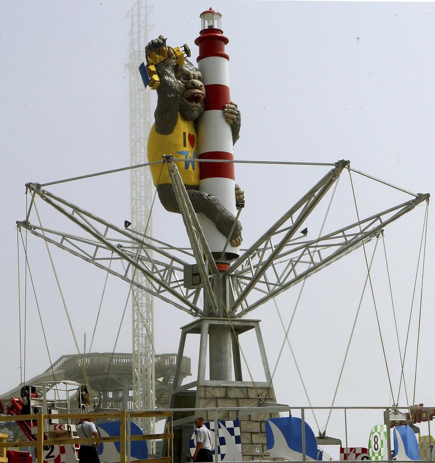 FILE - In this Sunday, May 10, 2015, file photo, Kong, a new ride attraction, is seen at Morey's Surfside Pier in North Wildwood, N.J. Kong was originally introduced on the pier in 1972 and was dismantled in 1980. In the new version, Kong wears an “I love Wildwood” t-shirt while clutching a famed Wildwood tram car and clinging to a 60-foot tall lighthouse at the ride’s center. (Dale Gerhard/The Press of Atlantic City via AP) MANDATORY CREDIT