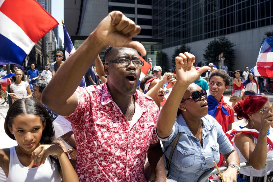 Attendees show a thumbs down and boo as New York City Mayor Bill de Blasio passes by during the Dominican Day Parade Sunday, Aug. 9, 2015, in New York. This year's Grand Marshall is Baseball Hall of Fame inductee Pedro Martinez. (AP Photo/Craig Ruttle) the photo