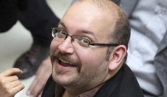 Jason Rezaian, an Iranian-American correspondent for The Washington Post, smiles as he attends a presidential campaign of President Hassan Rouhani in Tehran, Iran, in this April 11, 2013, file photo. (AP Photo/Vahid Salemi, File)