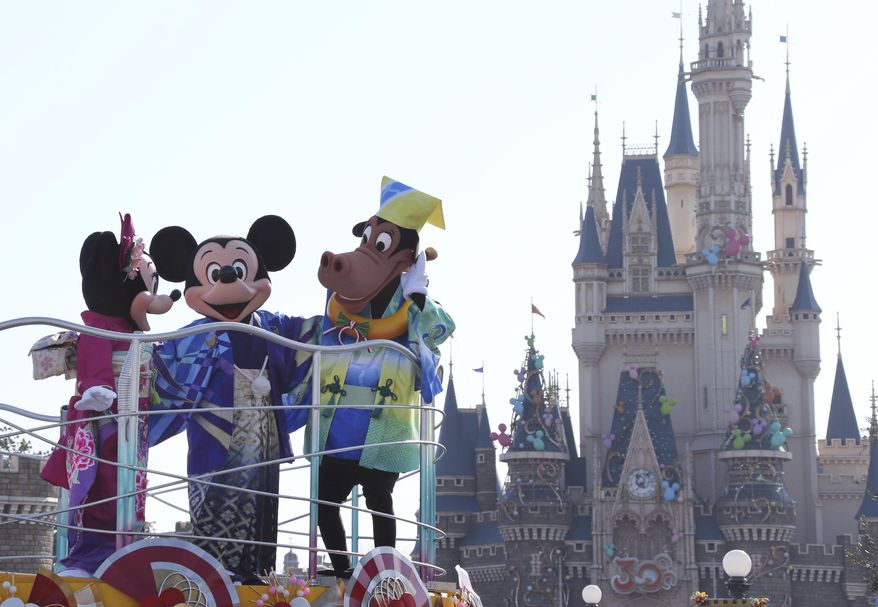 In this Jan. 1, 2014, file photo, Mickey Mouse, center, Minnie Mouse, left, and Horace Horsecollar, all clad in Japan&#39;s traditional kimono, entertain visitors to the Tokyo Disneyland during the New Year&#39;s celebration at the amusement park in Urayasu, east of Tokyo. (AP Photo/Koji Sasahara)