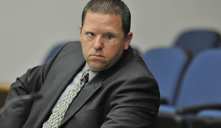 FILE - In this May 7, 2012 file photo, Fullerton police officer Jay Cicinelli listens to witness testimony during a preliminary hearing in Santa Ana, Calif. Cicinelli and Manuel Ramos policemen who were tried and ultimately acquitted in the beating death of a mentally ill homeless man in 2011 violated department policy on use of force and officer conduct, according to a previously confidential internal report. The report, prepared by an independent investigator, has come to light four years after Kelly Thomas' death as part of the evidence to be introduced at a civil wrongful death trial against the Fullerton Police Department. (Joshua Sudock/The Orange County Register via AP, Pool, File)