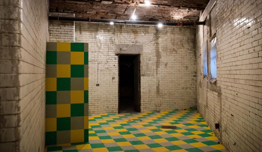 This April 2015 photo provided by No Longer Empty, a nonprofit arts group that installs exhibitions in empty and underutilized spaces, shows "Untitled, 2015" an installation by David Scanavino made of linoleum, applied to the floor and wall in one of the rooms of the Old Bronx Borough Courthouse, in New York. No Longer Empty does more than transform empty storefronts into temporary exhibition space. All its projects relate to the building’s history and its neighborhood. (No Longer Empty, Ian Douglas, via AP)