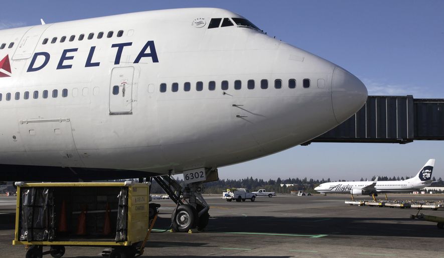 FILE - In this Oct. 9, 2012 file photo, Delta Air Lines 747-400 airplane sits parked at Seattle-Tacoma International Airport in Seattle. Delta Airlines on Monday, Aug. 3, 2015 said that it would no longer accept lion, leopard, elephant, rhinoceros and buffalo hunting trophies. (AP Photo/Ted S. Warren, File)