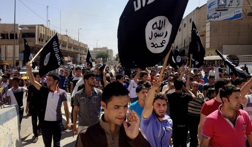 Demonstrators chant pro-Islamic State group slogans as they wave the group&#x27;s flags in front of the provincial government headquarters in Mosul, 225 miles (360 kilometers) northwest of Baghdad on June 16, 2014. (Associated Press) **FILE**
