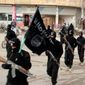 This undated file image posted on a militant website on Tuesday, Jan. 14, 2014, which has been verified and is consistent with other AP reporting, shows fighters from the al Qaeda-linked Islamic State of Iraq and the Levant (ISIL) or Islamic State of Iraq and Syria (ISIS), now called the Islamic State group, marching in Raqqa, Syria. (AP Photo/Militant Website, File)