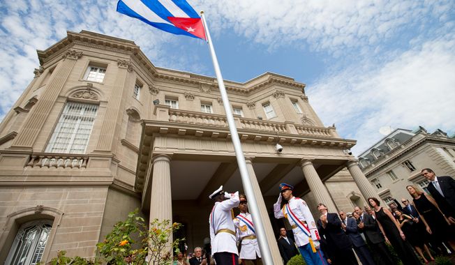 In this July 20, 2015, file photo, Cuban Foreign Minister Bruno Rodriguez, right of center, applauds with other dignitaries after raising the Cuban flag over their new embassy in Washington. The Obama administration doesn&#x27;t plan to invite Cuban dissidents to Secretary of State John Kerry&#x27;s historic flag-raising at the U.S. Embassy in Havana on Friday, Aug. 14, vividly illustrating how U.S. policy is shifting focus from the island&#x27;s opposition to its single-party government. (AP Photo/Andrew Harnik, Pool, File)