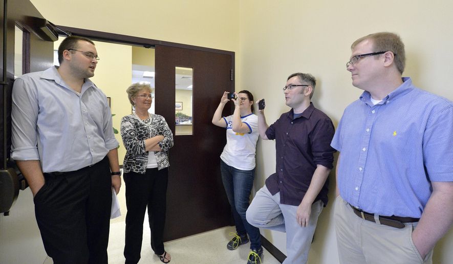 CORRECTS TO SAY THAT THE CLERK'S OFFICE WILL NOT BE ISSUING ANY MARRIAGE LICENSES, REGARDLESS OF WHETHER STRAIGHT OR SAME-SEX - Rowan County clerks Nathan Davis, left, and Roberta Earley, second left, inform David Ermold, right, and David Moore, second from right, that the county clerk's office will not be issuing marriage licenses to any couple, in defiance of an order from a federal judge, in Morehead, Ky., Thursday, Aug. 13, 2015. Rowan County Clerk Kim Davis has already filed a notice of appeal and plans to request a stay on the ruling. (AP Photo/Timothy D. Easley)