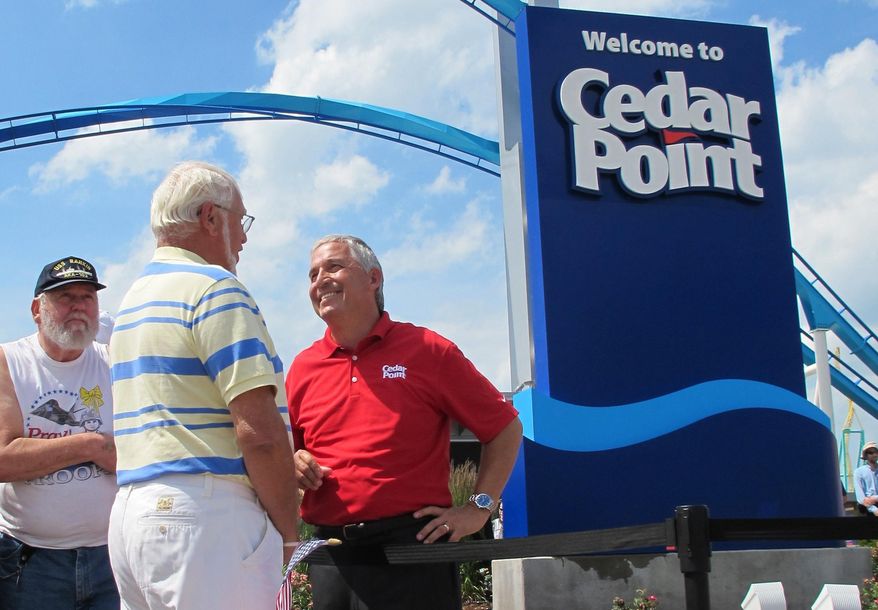 FILE - In this July 2, 2014, file photo, Matt Ouimet, chief executive of Cedar Fair Entertainment Co., greets a guest at Cedar Point amusement park, in Sandusky, Ohio. A man who entered a restricted area at the amusement park to look for a lost cellphone has been struck by a roller coaster and killed Thursday, Aug. 13, 2015. (AP Photo/John Seewer, File)