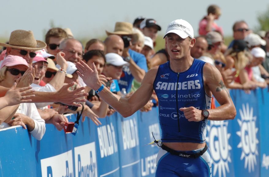 FILE - In this Aug. 10, 2014, file photo, Lionel Sanders, from Hamilton, Ontario, heads toward the finish line as he wins the men's pro division of the Maytag Steelhead Ironman 70.3 Triathlon race at Jean Klock Park in Benton Harbor, Mich. When life was at its most bleak, Sanders sought solace in what he knew best. He ran. Every day for a month straight, he ran, the first steps out of a life of using hard drugs to becoming one of the world's top young professional triathletes. (Don Campbell/The Herald-Palladium via AP) MANDATORY CREDIT