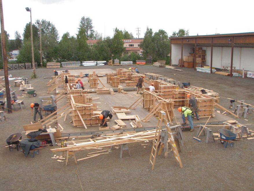 ADVANCE FOR SATURDAY AUG. 15 AND THEREAFTER - In this July 2, 2015 photo, first-year Southern Alaska Carpenter Training Center students practice their metal framing and drywall skills in Anchorage, Alaska. The center currently accepts about 40 new students per year and is looking to expand its facilities in South Anchorage (Elwood Brehmer/Alaska Journal of Commerce via AP)