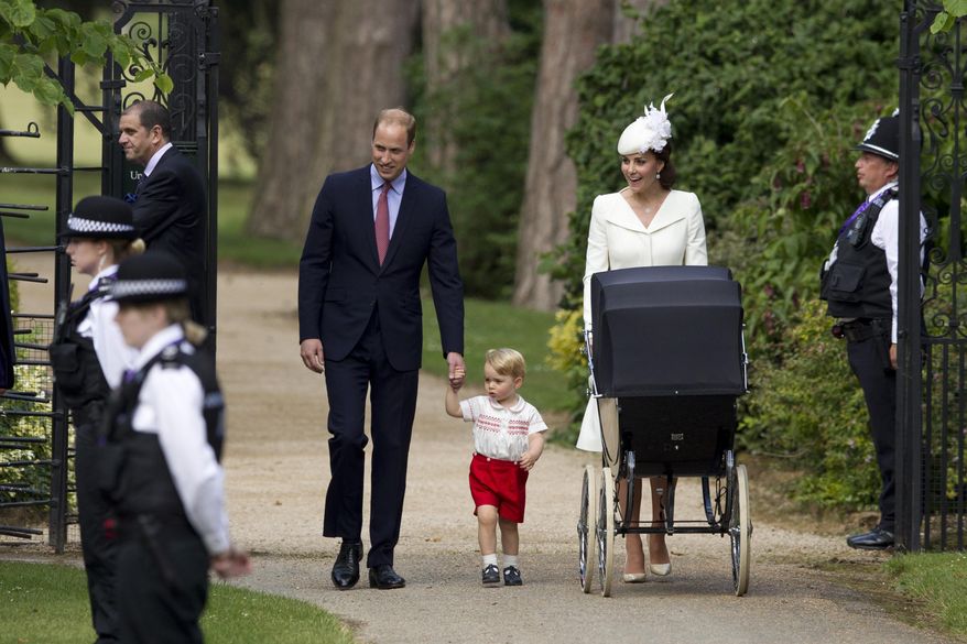 FILE- In this file photo dated Sunday, July 5, 2015, Britain's Prince William, Kate the Duchess of Cambridge, their son Prince George walk with their daughter Princess Charlotte in a pram, during an official media event as they arrive for Charlotte's Christening at St. Mary Magdalene Church in Sandringham, England. Royal officials at Kensington Palace are urging all media organizations not to publish images of Prince George and Princess Charlotte, by some paparazzi photographers who are using increasingly dangerous tactics to snap images of the royals, which presents a risk “in a heightened security environment.’’ (AP Photo/Matt Dunham, FILE)