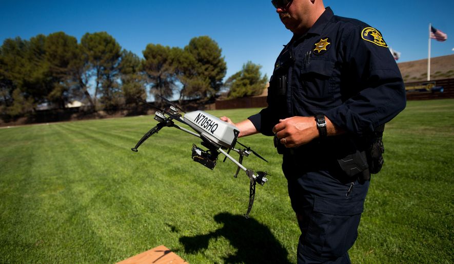 Alameda County Sheriff&#39;s Deputy Dave Durbin prepares to fly a drone during a demonstration of a search and rescue operation on Friday, Aug. 14, 2015, in Dublin, Calif. As law enforcement joins the ranks of hobbyists sending drones into California skies, civil liberties advocates are raising the specter of unchecked police surveillance and state lawmakers are drafting limits. (AP Photo/Noah Berger)