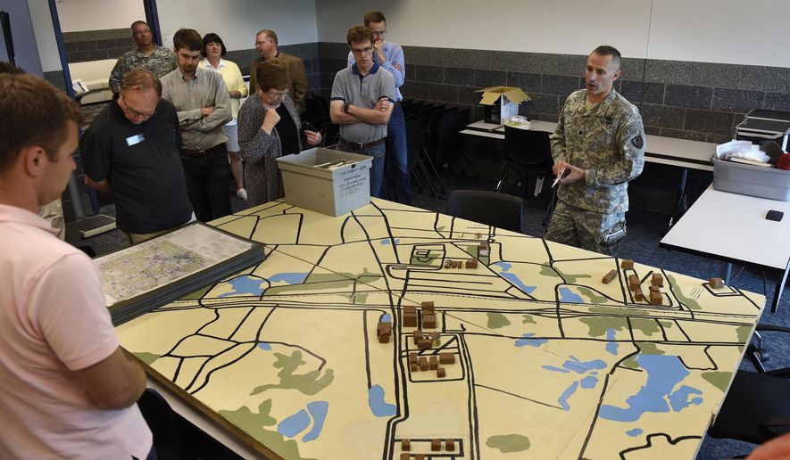 Minnesota House capital investment committee members are given a tour of a classroom in the new education center Thursday, Aug. 13, 2015, at Camp Ripley in Little Falls, Minn. Camp Ripley officials and the state Department of Public Safety are asking state legislators for $3.1 million in bonding money to build a regional facility that would help emergency workers prepare for oil train derailment and pipeline disasters at the military base in Little Falls, the St. Cloud Times reported. (Dave Schwarz/St. Cloud Times via AP) NO SALES; MANDATORY CREDIT