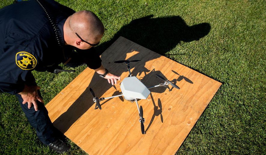 Alameda County Sheriff's Deputy Dave Durbin prepares to fly a drone during a demonstration of a search and rescue operation on Friday, Aug. 14, 2015, in Dublin, Calif. As law enforcement joins the ranks of hobbyists sending drones into California skies, civil liberties advocates are raising the specter of unchecked police surveillance and state lawmakers are drafting limits. (AP Photo/Noah Berger)