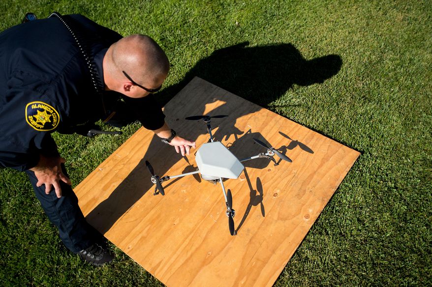Alameda County Sheriff's Deputy Dave Durbin prepares to fly a drone during a demonstration of a search and rescue operation on Friday, Aug. 14, 2015, in Dublin, Calif. As law enforcement joins the ranks of hobbyists sending drones into California skies, civil liberties advocates are raising the specter of unchecked police surveillance and state lawmakers are drafting limits. (AP Photo/Noah Berger)