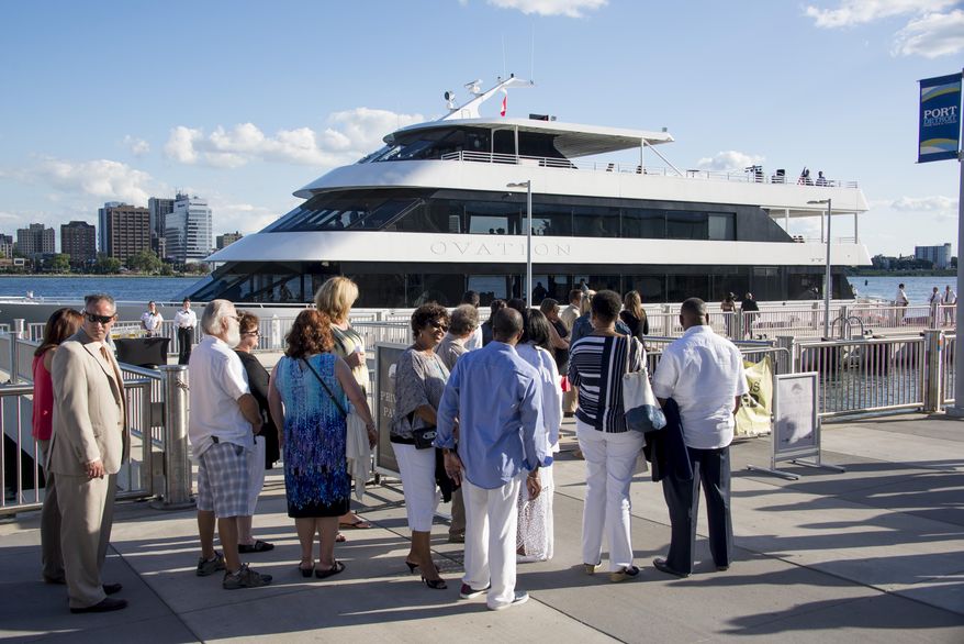 In this photo taken Wednesday, Aug. 12, 2015, party-goers wait to board the Ovation as it sits docked outside the Port Authority dock on Atwater Street in Detroit. A $22 million port development along downtown Detroit's riverfront that aimed to be a stopping point for Great Lakes cruise ships hasn't worked out as planned. The Detroit News reports that four years after construction of the Detroit/Wayne County Port Authority public dock the facilities are used almost exclusively by a catering company for weddings and other events. Parties also are offered on a yacht. (David Guralnick /Detroit News via AP) DETROIT FREE PRESS OUT; HUFFINGTON POST OUT; MANDATORY CREDIT