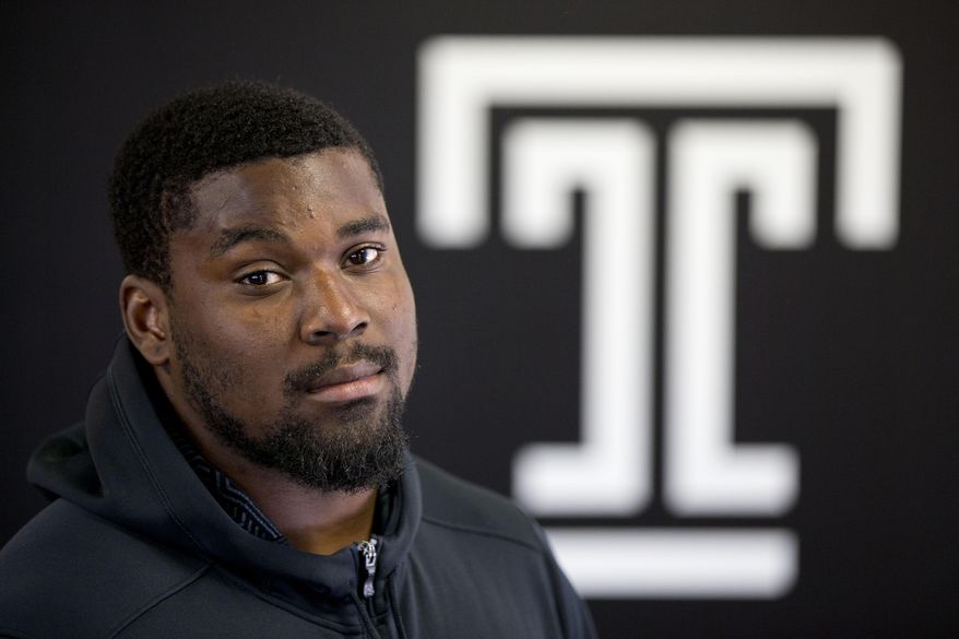 In this Thursday, Aug. 13, 2015, photo, Temple University football player Praise Martin-Oguike poses for a photograph in Philadelphia. The defensive end from Temple lost two years of his college football career after being charged in May 2012 with raping a female student. Not until 18 months had past, after he had been kicked off the team and out of school did, did prosecutors find evidence on the accuser's cell phone supporting Martin-Oguike's claims of innocence. With jury selection for his trial in progress, the charges were dismissed. (AP Photo/Matt Rourke)