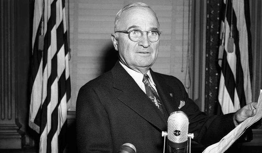 Wearing the same stern expression that characterized his press conference appearance, President Harry S. Truman repeats for cameramen (who were excluded at the news session) his warning that U.N. forces would not back down in Korea and the atom bomb would be used if necessary to meet the military situation. The re-enactment was in the same executive office room in Washington, Nov. 30, 1950 where his press conferences are held. (AP Photo/Henry Griffin)