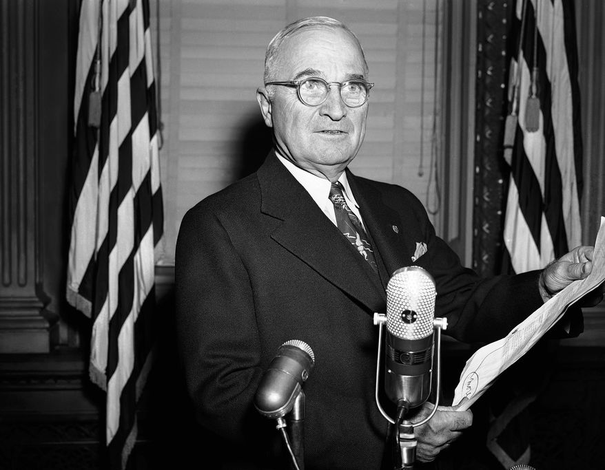 Wearing the same stern expression that characterized his press conference appearance, President Harry S. Truman repeats for cameramen (who were excluded at the news session) his warning that U.N. forces would not back down in Korea and the atom bomb would be used if necessary to meet the military situation. The re-enactment was in the same executive office room in Washington, Nov. 30, 1950 where his press conferences are held. (AP Photo/Henry Griffin)