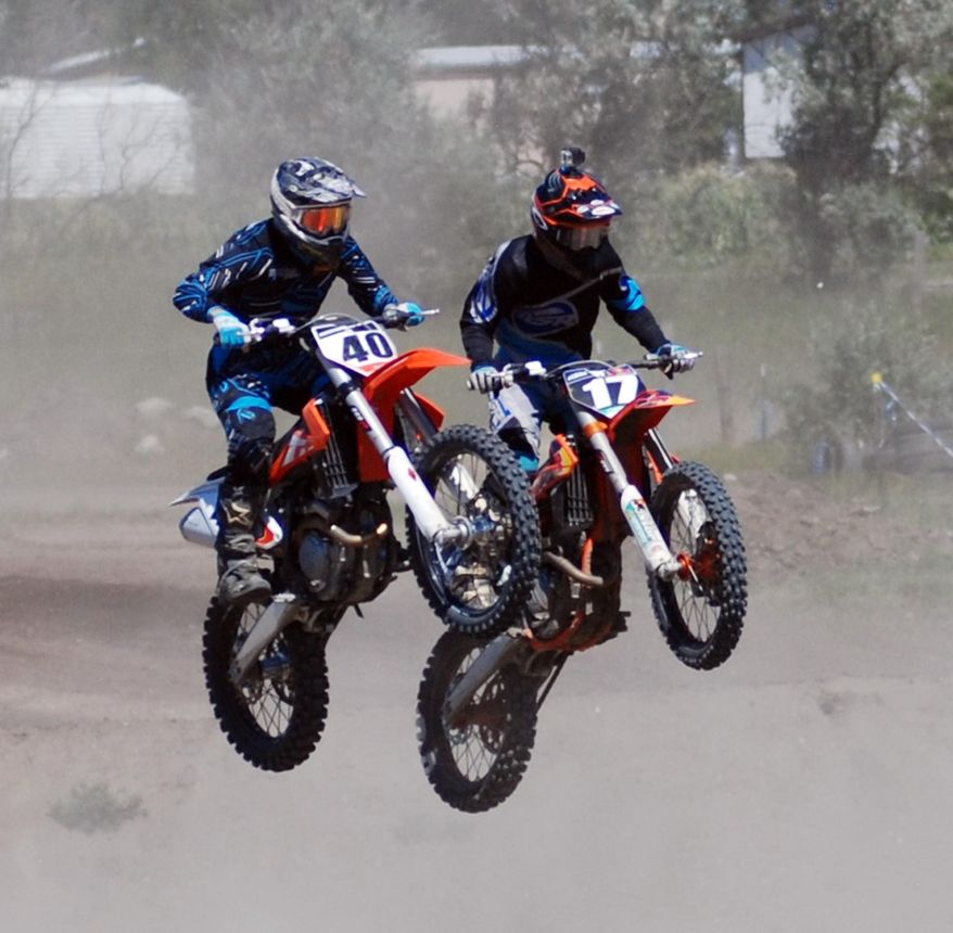 In this Saturday, Aug. 8, 2015 photo, Riders participate in the first annual Kris Barnes Memorial motocross race was held in Ruthville, N.D. Racers from ages 4-57 competed in the eight-hour race day, which honored Kris Barnes, who was killed in an oil-drilling rig accident in March 2014. (John Denega/The Minot Daily News via AP)