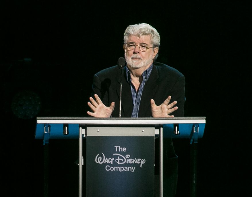 CORRECTS YEAR TO 2015, NOT 2014 - "Star Wars" creator, filmmaker George Lucas is honored with the Disney Legends Award, Friday, Aug. 14, 2015, in Anaheim, Calif. Lucas sold his company, and his iconic "Star Wars" film franchise, to Disney for $4 billion. (AP Photo/Damian Dovarganes)