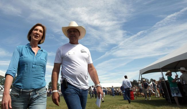Republican presidential candidate Carly Fiorina is escorted by Tom Stone from Gardnerville, Nevada, after arriving at the Inaugural Basque Fry at Corley Ranch in Gardnerville on Aug. 15, 2015. (Associated Press)