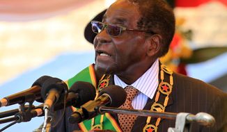Zimbabwean President Robert Mugabe delivers a speech during a ceremony in Harare, Monday Aug. 10, 2015, honouring thousands of fighters who died in a 1970s Bush war against colonialism. Mugabe, in his first public comments about the popular lion named Cecil, says his compatriots failed in their responsibility to protect the lion that was killed by an American in an allegedly illegal hunt. (AP Photo/Tsvangirayi Mukwazhi)