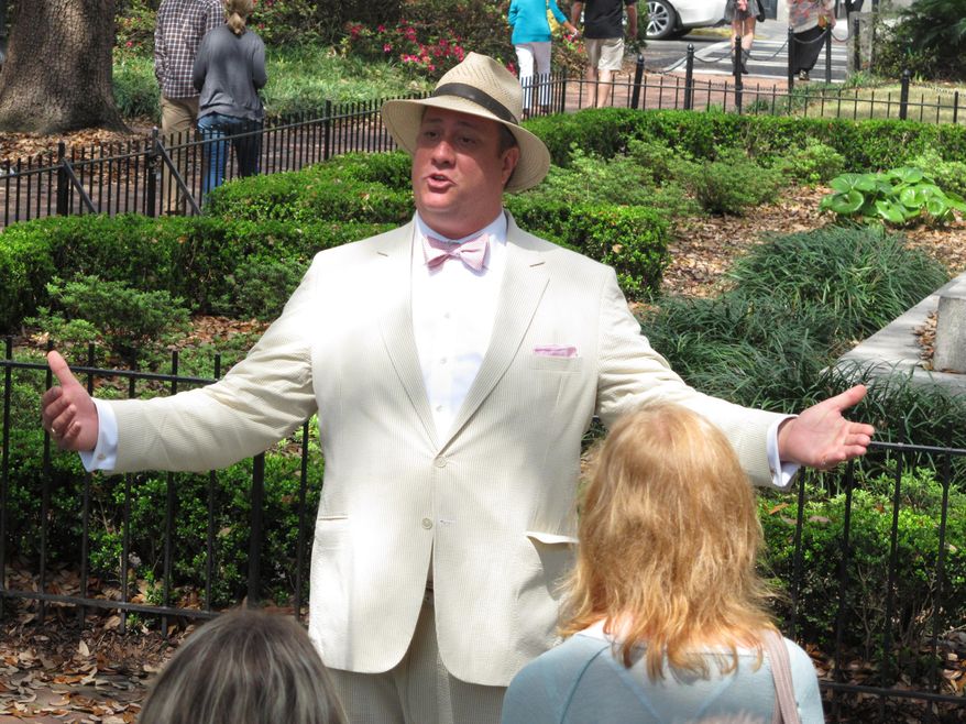 FILE - In this Friday, March 20, 2015 file photo, Dan Leger, who works under the name Savannah Dan, talks with visitors while leading a guided tour of downtown Savannah, Ga. The local government in Savannah requires tour guides to earn a license by passing a 100-question test on Savannah's history, key locations and architecture. A federal lawsuit challenging the licensing law says it violates guides' free-speech rights. (AP Photo/Russ Bynum, File)