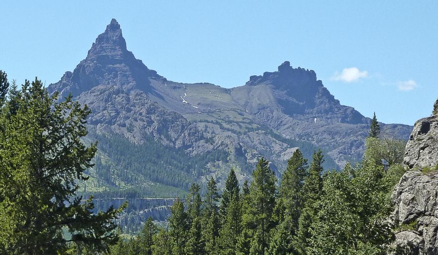 In this July 29, 2015 photo, Pilot and Index peaks dominate the Clarks Fork River valley just east of Yellowstone National Park, where Ernest Hemingway fished, hunted and wrote in the 1930s. Hemingway first arrived at the Clarks Fork River valley on July 13, 1931, bouncing along Yellowstone National Park’s gravel roads in a Ford Model A roadster until he reached one of the wildest places in America. (Keith McCafferty/Bozeman Daily Chronicle via AP)