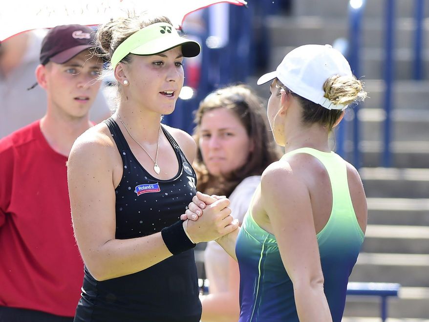 Belinda Bencic, of Switzerland, shakes hands with Simona Halep, of Romania, after the women's final at the Rogers Cup tennis tournament in Toronto, Sunday, Aug. 16, 2015. Halep retired in the third set due to injury. (Frank Gunn/The Canadian Press via AP)