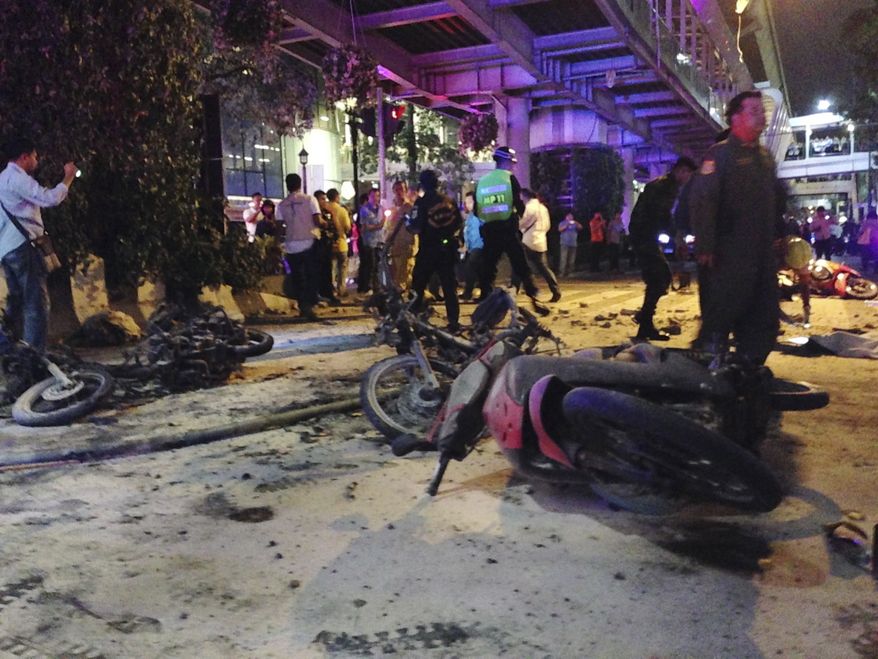 Motorcycles are strewn about after an explosion in Bangkok, Monday, Aug. 17, 2015. A large explosion rocked a central Bangkok intersection during the evening rush hour, killing a number of people and injuring others, police said. (AP Photo/Jerry Harmer)