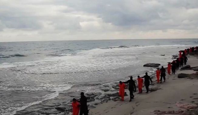 This image made from a video released Feb. 15, 2015, by militants in Libya claiming loyalty to the Islamic State purportedly shows Egyptian Coptic Christians in orange jumpsuits being led along a beach before being executed. (Associated Press)