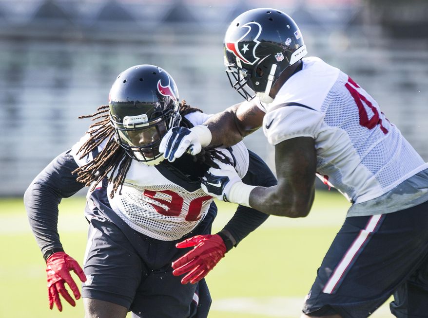 Houston Texans linebacker Jadeveon Clowney (90) and Lynden Trail (47) run a drill during the Texans NFL football training camp Monday, Aug. 17, 2015, in Houston. Clowney returned to practice on a limited basis for the first time since microfracture knee surgery in December. (Brett Coomer/Houston Chronicle via AP) MANDATORY CREDIT