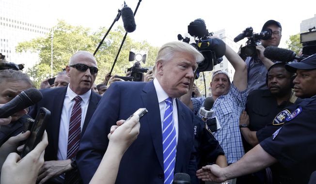 Republican presidential candidate Donald Trump is surrounded by media as he arrives for jury duty in New York, Monday, Aug. 17, 2015.  The front-runner said last week before a rally in New Hampshire that he would willingly take a break from the campaign trail to answer the summons. (AP Photo/Richard Drew)