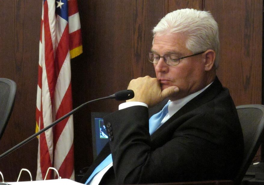Kansas Corporation Commission member Pat Apple follows comments from witnesses during a hearing on an agreement that would allow Westar Energy Inc. to increase its annual electric rates by $78 million, Monday, Aug. 17, 2015, in Topeka, Kan. The rate-setting KCC must decide whether to accept the agreement. (AP Photo/John Hanna)