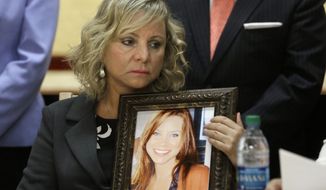 Debbie Ziegler holds a photo of her daughter, Brittany Maynard, the California woman with brain cancer who moved to Oregon to legally end her life last fall, during a news conference to announce the reintroduction of right to die legislation, Tuesday, Aug. 18, 2015, in Sacramento,Calif.  The measure, by Assemblywoman Susan Talamantes Eggman, D-Stockton, Bill Monning, D-Carmel, Sen. Lois Wolk, D-Davis, and other lawmakers would allow terminally ill patients to take life ending drugs.  A nearly identical bill  failed to get out of a legislative committee earlier this year.  (AP Photo/Rich Pedroncelli)