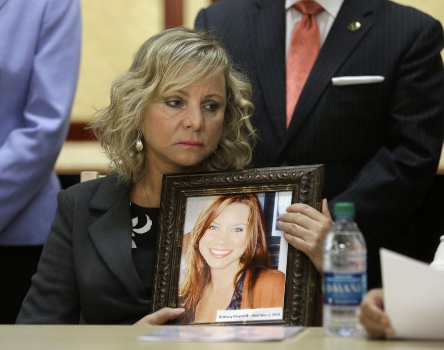 Debbie Ziegler holds a photo of her daughter, Brittany Maynard, the California woman with brain cancer who moved to Oregon to legally end her life last fall, during a news conference to announce the reintroduction of right to die legislation, Tuesday, Aug. 18, 2015, in Sacramento,Calif. The measure, by Assemblywoman Susan Talamantes Eggman, D-Stockton, Bill Monning, D-Carmel, Sen. Lois Wolk, D-Davis, and other lawmakers would allow terminally ill patients to take life ending drugs. A nearly identical bill failed to get out of a legislative committee earlier this year. (AP Photo/Rich Pedroncelli)