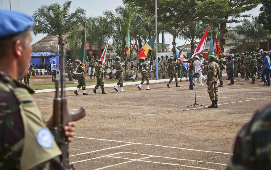 FILE - In this Sept. 15, 2014, file photo, U.N. peace keeping troops take part in a ceremony in the capital city of Bangui, Central African Republic (CAR), to take over a regional African peacekeeping mission. In CAR, a dozen allegations of sexual misconduct have been received since the mission there was established in April 2014, the peacekeeping office in New York says. Stretched for resources with a record number of peacekeepers in the field, the U.N. has hesitated to upset member states by announcing the countries whose troops or police are accused of wrongdoing, until now. Last week, UN Secretary-General Ban Ki-moon announced his intention to do so. (AP Photo, File)