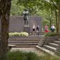 People walk past a statue of Gen. John J. Pershing, who had served as general of the Armies in World War I, in Pershing Park, at 14th Street and Pennsylvania Avenue NW, in Washington, Wednesday, Aug. 19, 2015. (AP Photo/Carolyn Kaster) ** FILE **